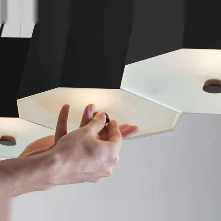 Faceted metal linear pendant, close-up of the frosted diffuser and beech stopper