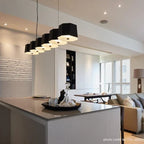 Faceted metal linear pendant, above a kitchen island
