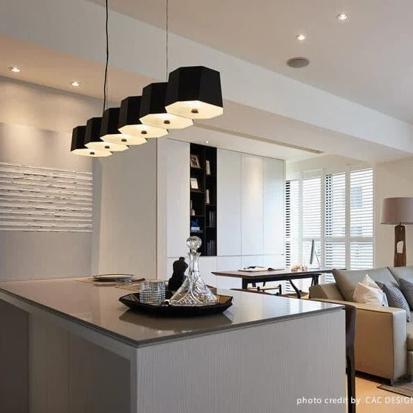 Faceted metal linear pendant, above a kitchen island