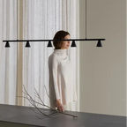 Five-cone adjustable linear LED pendant, above a kitchen island
