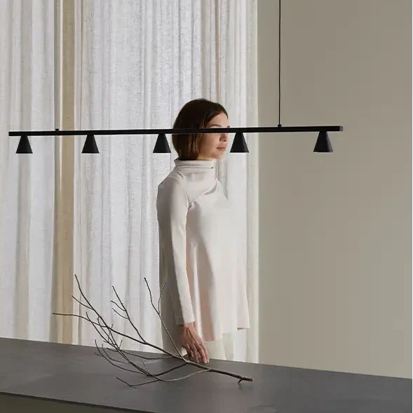 Five-cone adjustable linear LED pendant, above a kitchen island