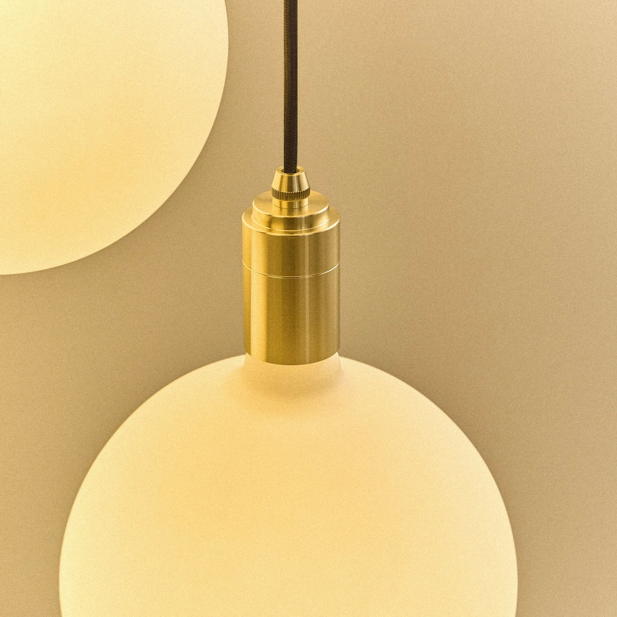 Five-drop cluster pendant with opal globe bulbs, brass, close-up of a brass holder and globe bulb