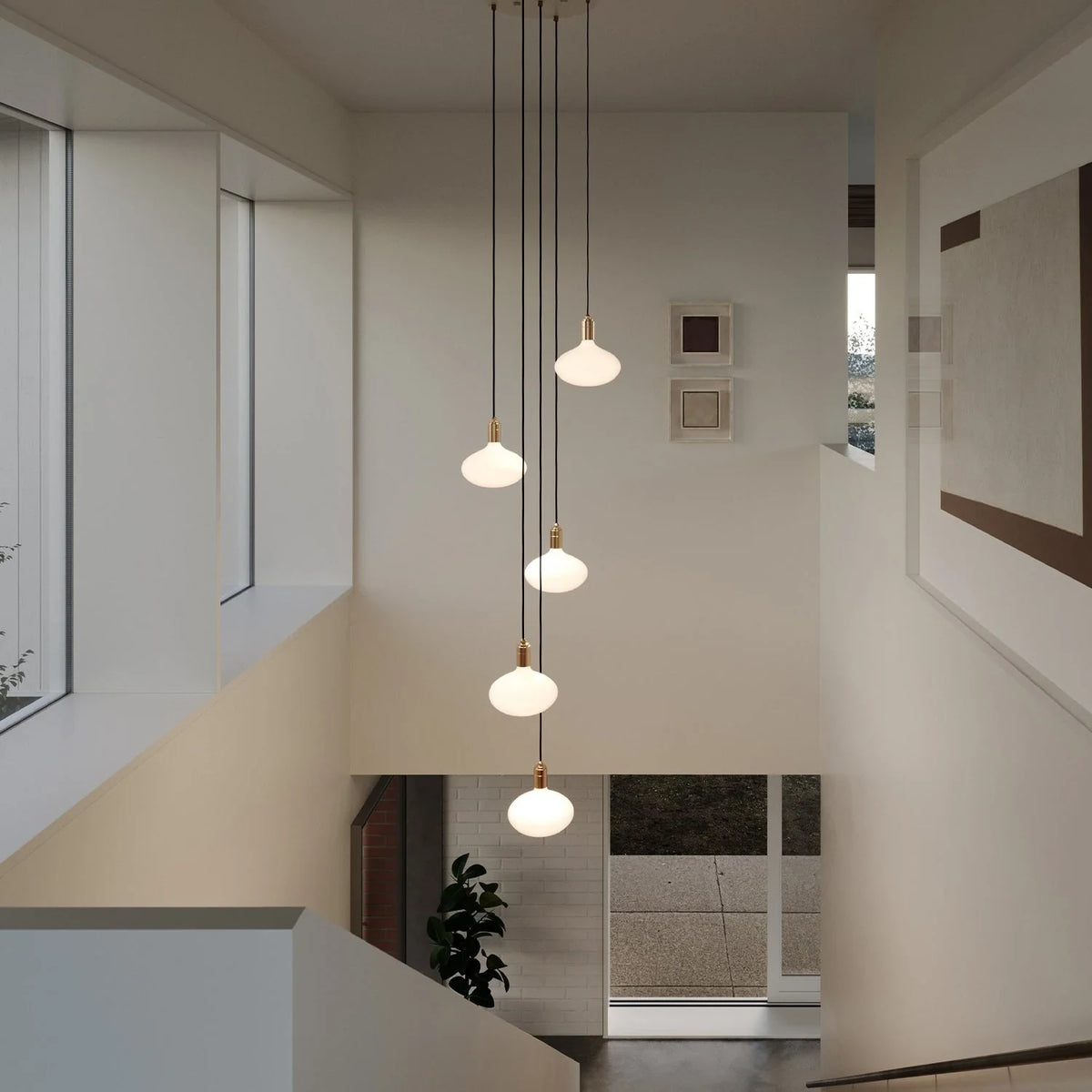 Five-drop cluster pendant with opal oval bulbs, brass, in a stairwell