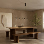 Five-light marble spot linear pendant, above a long wooden dining table