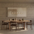 Five marble cone linear LED pendant, above a long dining table