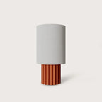 Fluted ceramic drum table lamp base, in terracotta with a white shade (sold separately)
