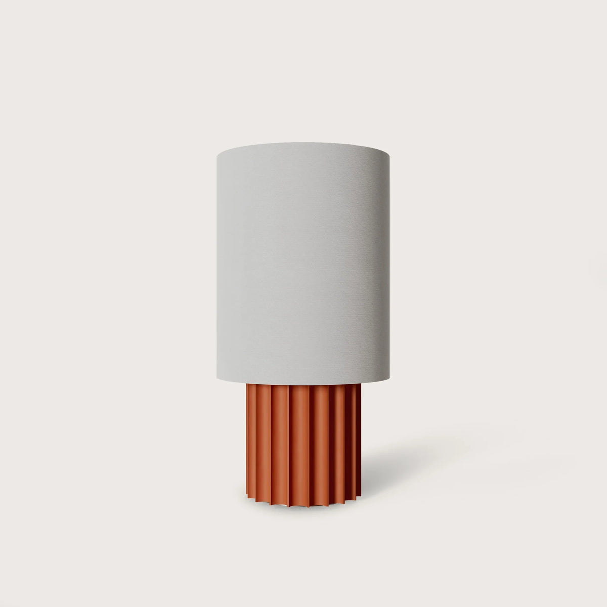 Fluted ceramic drum table lamp base, in terracotta with a white shade (sold separately)