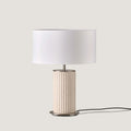 Fluted ceramic table lamp, in cream, with a white drum shade (not included)