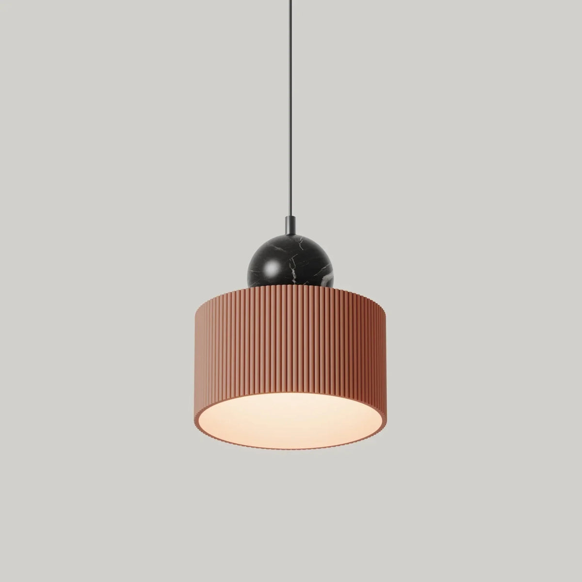 Fluted drum LED pendant with marble sphere, in terracotta with black marble, side view