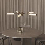 Fluted glass tube LED chandelier, above a round dining table