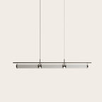 Fluted glass tube linear LED pendant, on a plain background
