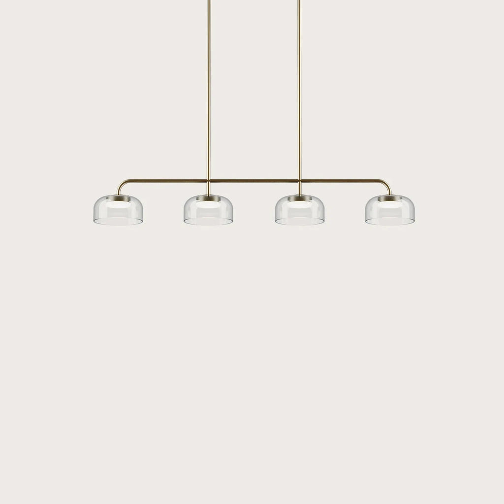 Four-dome linear glass pendant with integrated LED, gold bar with four clear shades on a plain background