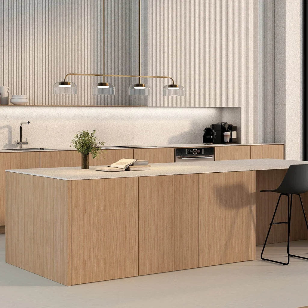 Four-dome linear glass pendant with integrated LED, above a kitchen island