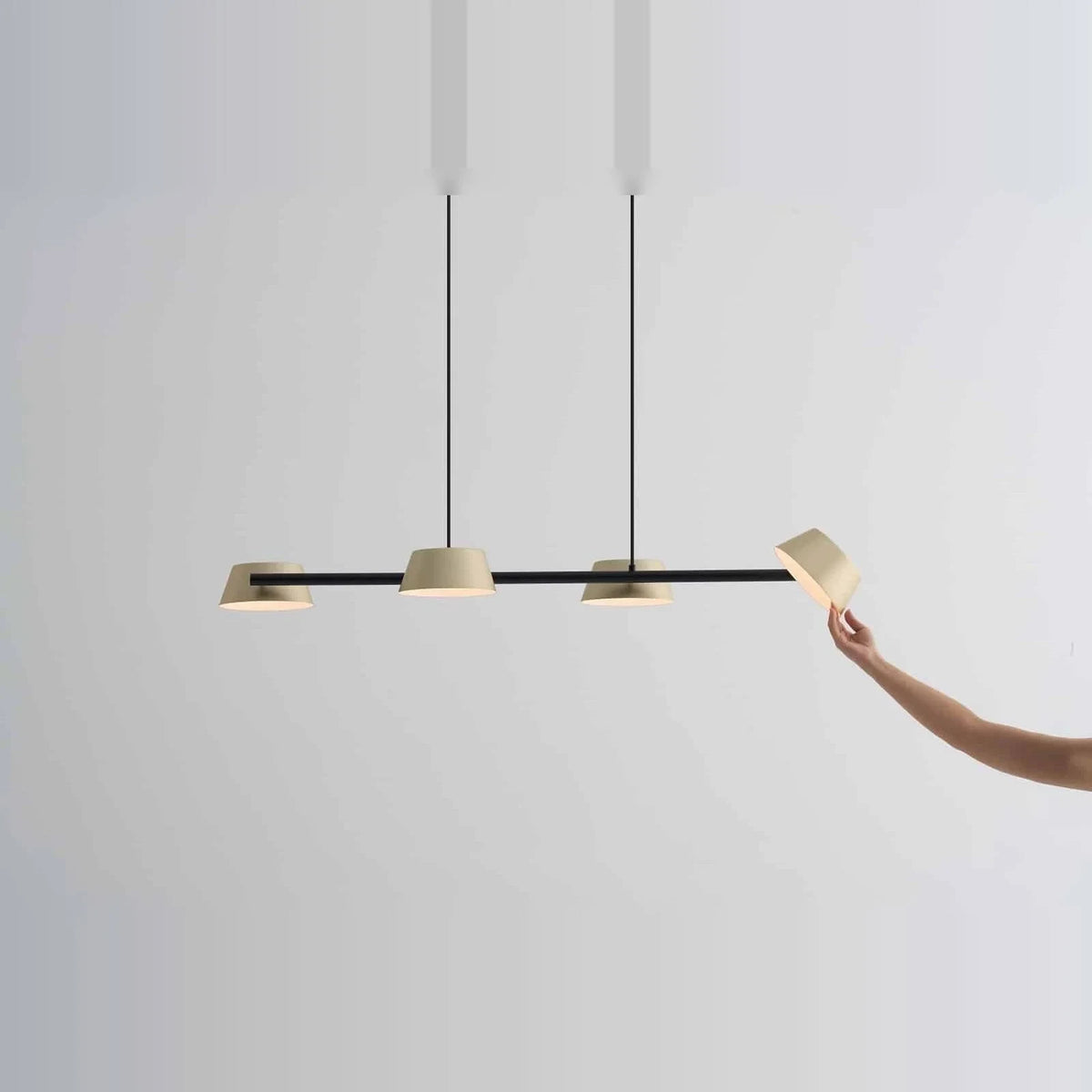 Four-head hollow cone linear LED pendant, in champagne gold, angling a head