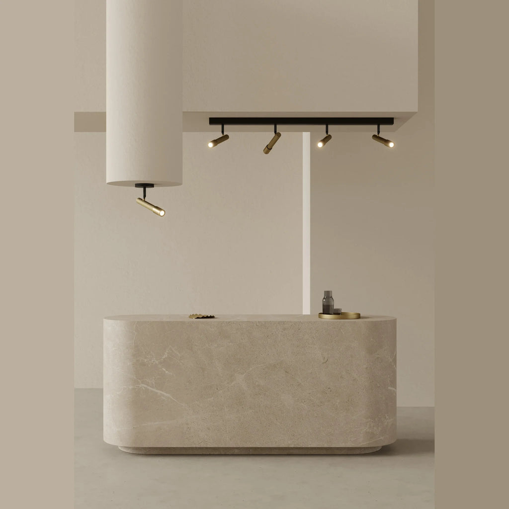 Four-spot ceiling bar light, above a stone-topped island