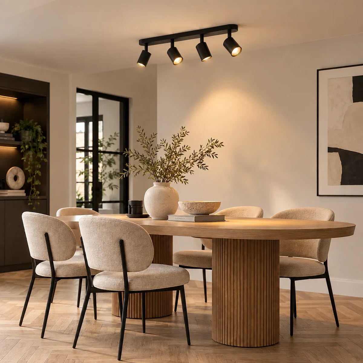 Four-spotlight ceiling bar light in matt black, above a dining table