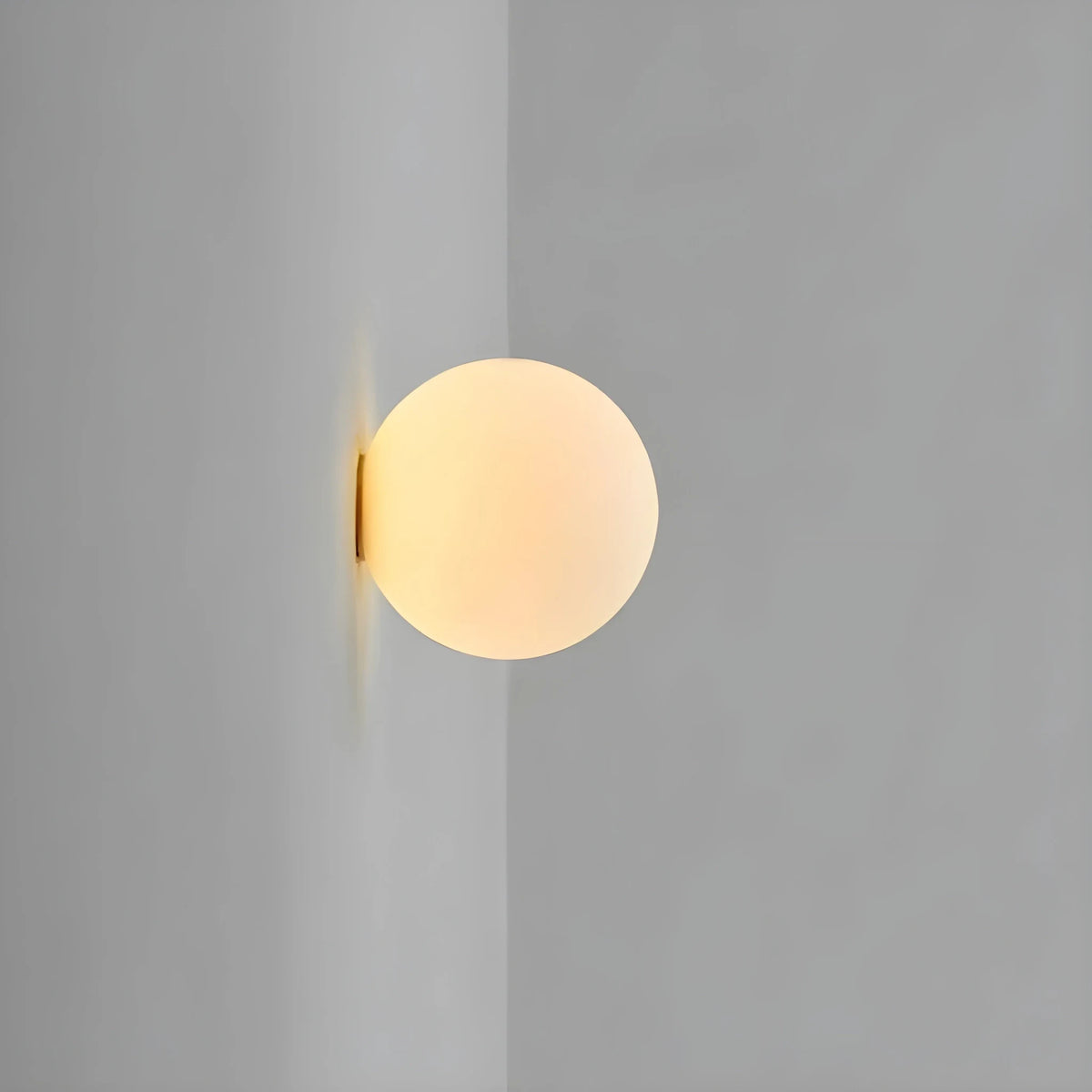 Frosted glass globe wall light, unlit, side view