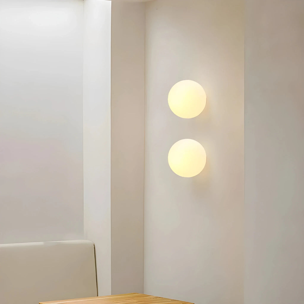 Frosted glass globe wall light, a pair lit on a white wall