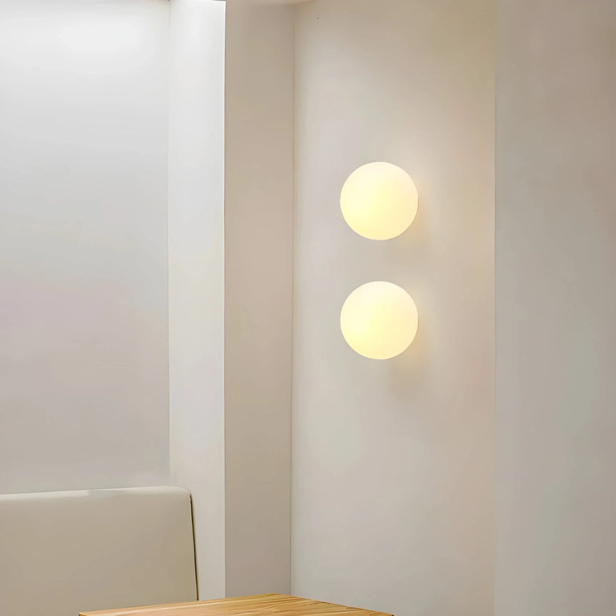 Frosted glass globe wall light, a pair lit on a white wall