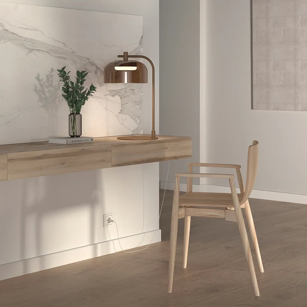 Arc table lamp with glass dome shade, on a wall shelf beside a wooden chair