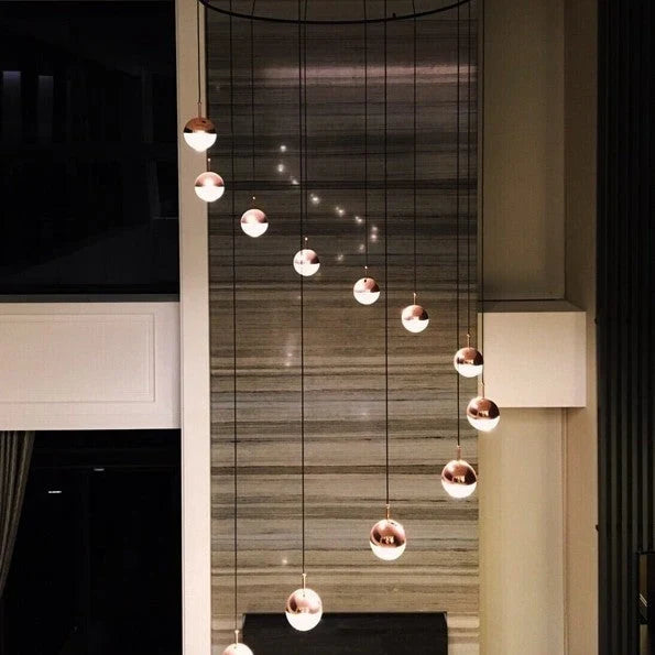 Glass globe cluster pendant, in a double-height stairwell