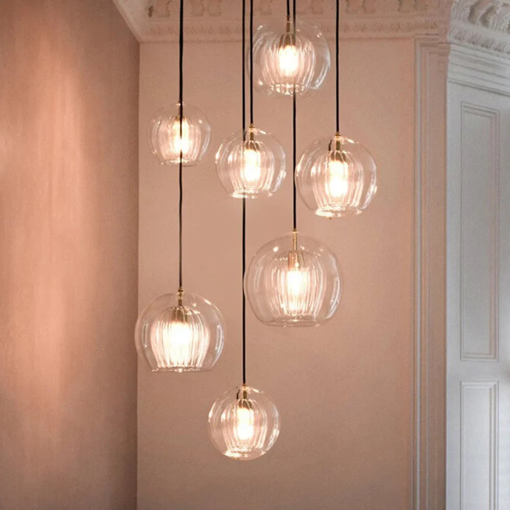 Ribbed glass globe pendant light, clear glass, hung in a cluster
