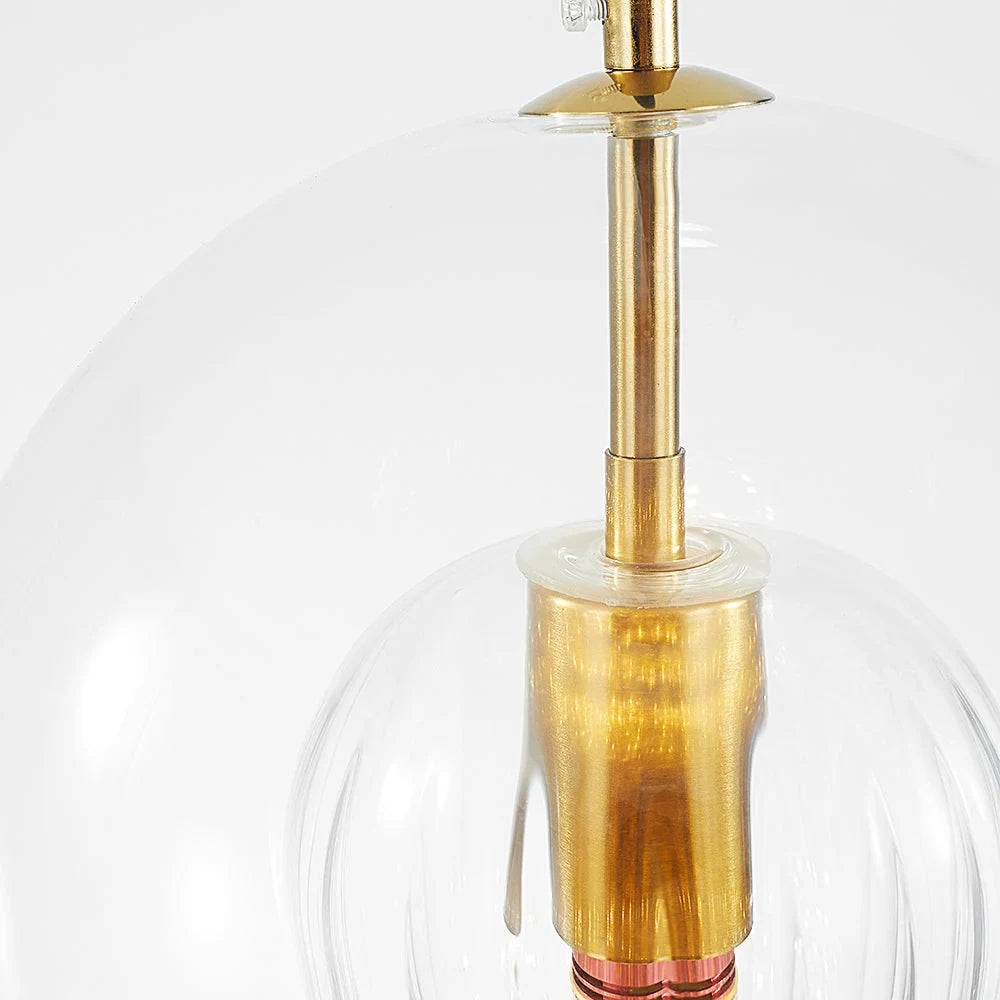 Ribbed glass globe pendant light, close-up of the brass-finish fitting