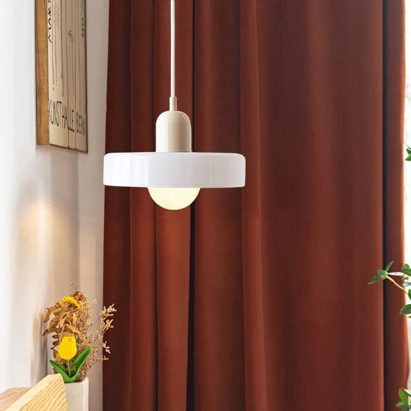 Glass pendant light with ring shade, white, by a red curtain