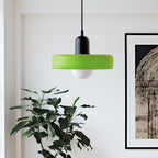 Glass pendant light with ring shade, green, beside a plant