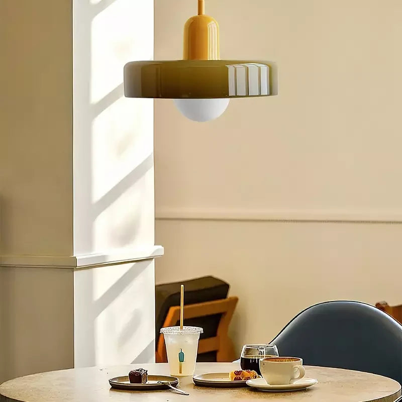 Glass pendant light with ring shade, army green, in a sunny room