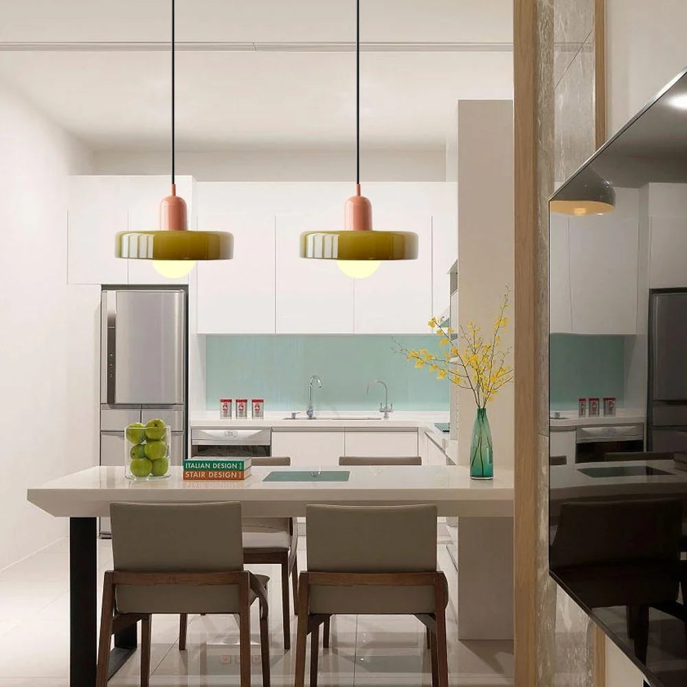 Glass pendant light with ring shade, army green pair above a kitchen table