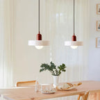 Glass pendant light with ring shade, white pair above a table