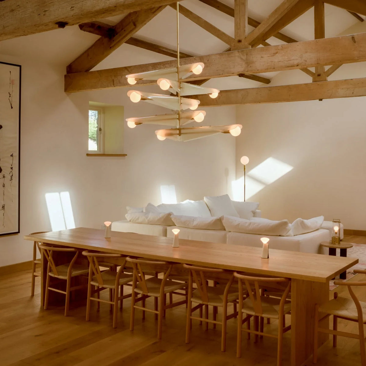 Glass wing chandelier, above a long dining table