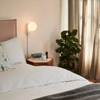 Globe table lamp or wall light, chalk, wall-mounted in a bedroom