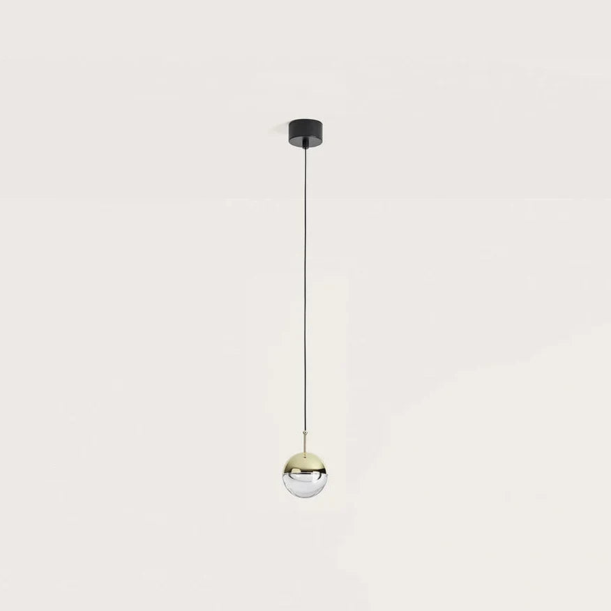 Gold and optic glass sphere LED pendant, hanging on its slim black cable