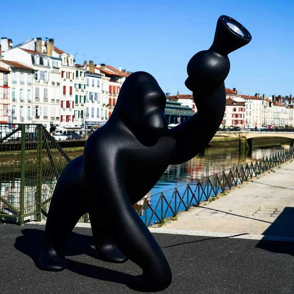 Gorilla floor lamp with an adjustable arm