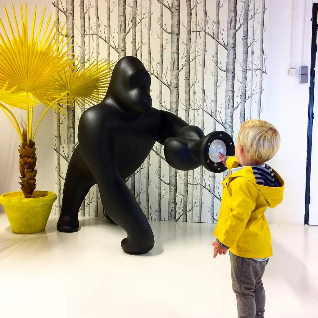 Gorilla floor lamp with an adjustable arm