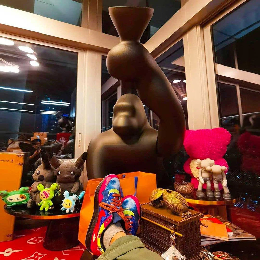 Gorilla floor lamp with an adjustable arm