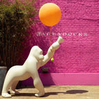 Gorilla floor lamp with an adjustable arm