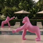 Gorilla floor lamp with an adjustable arm, in pink by a pool