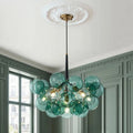 Green glass bubble chandelier, below a ceiling rose in a panelled room
