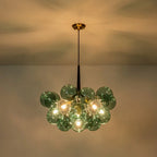 Green glass bubble chandelier, lit against the ceiling