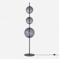 Modular hand-blown glass globe floor lamp, in black with smoke grey glass