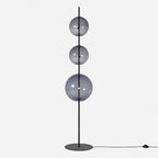 Modular hand-blown glass globe floor lamp, in black with smoke grey glass