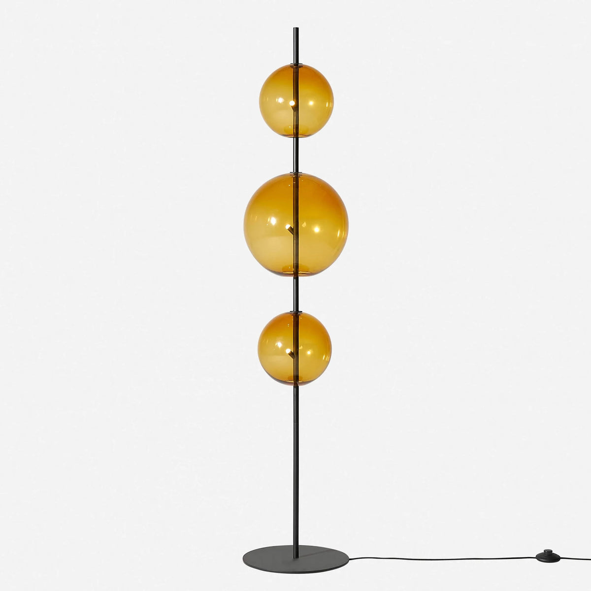 Modular hand-blown glass globe floor lamp, in amber glass