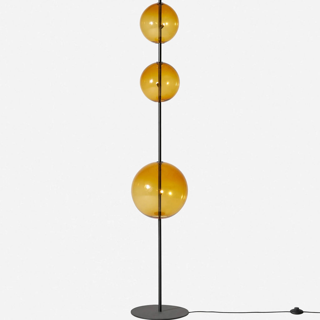 Modular hand-blown glass globe floor lamp, in amber glass