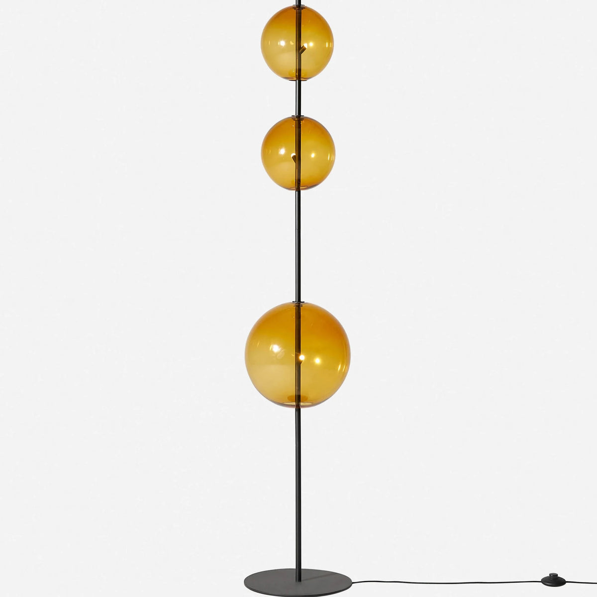 Modular hand-blown glass globe floor lamp, in amber glass