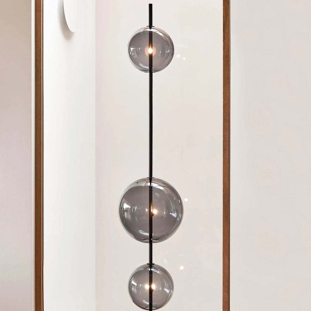 Modular hand-blown glass globe floor lamp, close-up of the smoke grey glass spheres