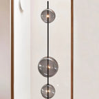 Modular hand-blown glass globe floor lamp, close-up of the smoke grey glass spheres