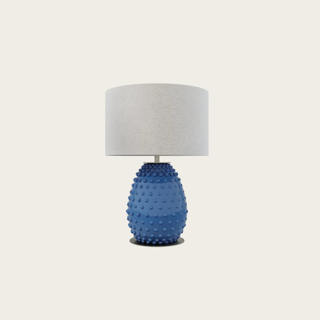 Hand-painted bobble glass table lamp with drum shade, in blue on a plain background